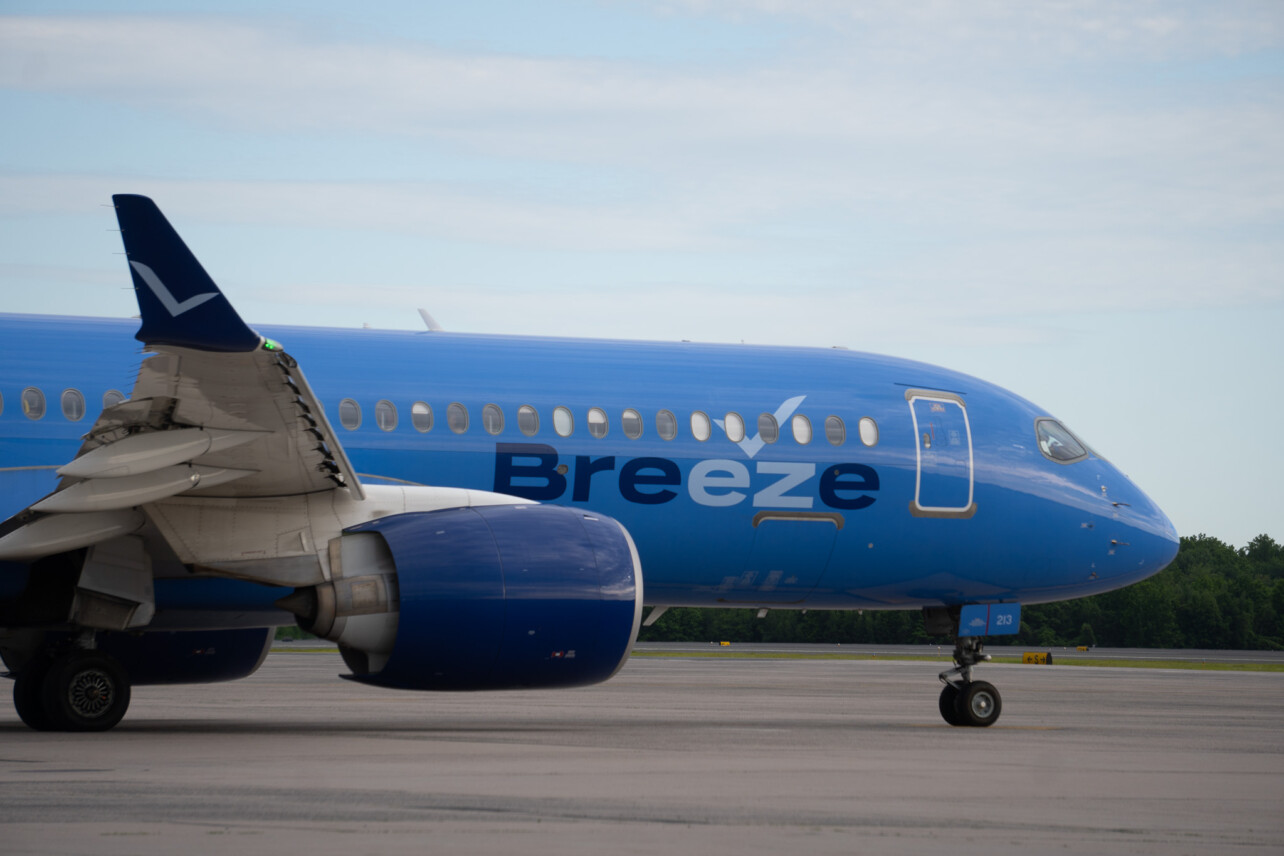 A blue Breeze Aircraft taxiing and facing right at Bradley International Airport